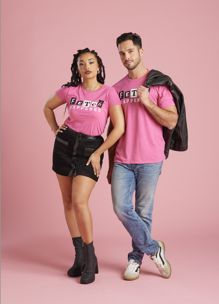 Two models in Fetch Happened tees on a pink backdrop