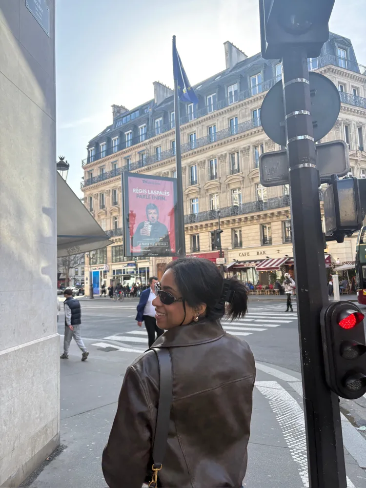 Whitney in sunglasses on a Paris street corner